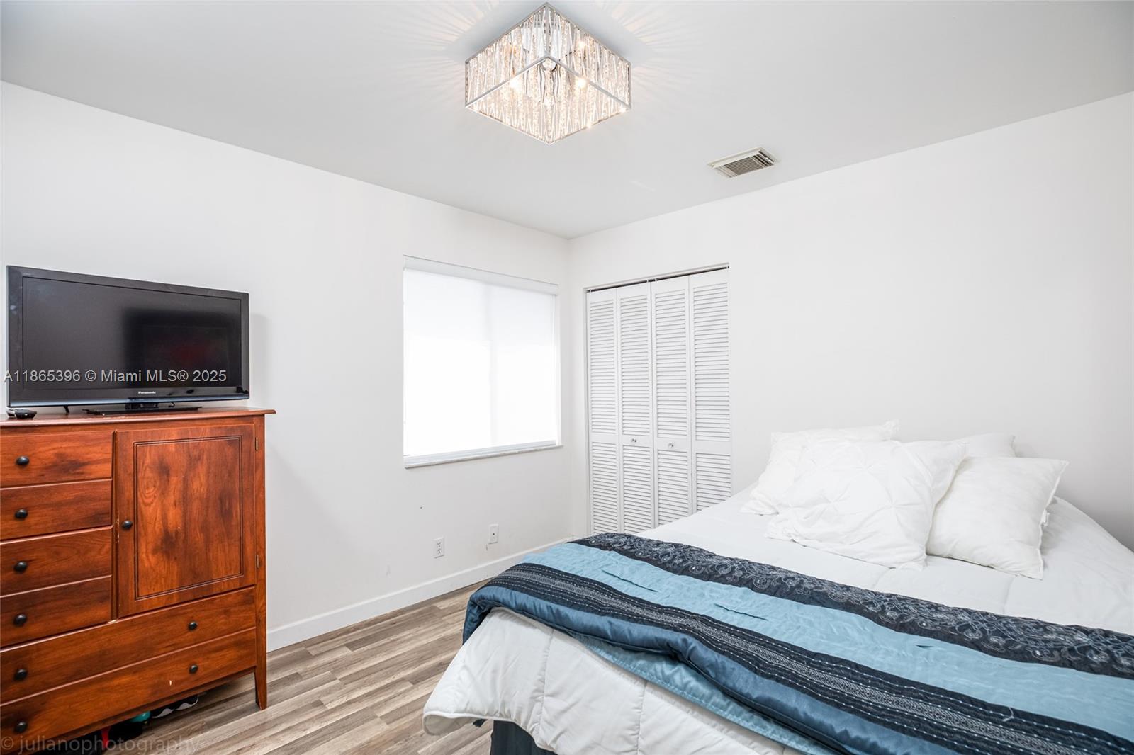 4913 Southwest 32nd Way Hollywood, FL 33312 - Photo 18 of 27 a bedroom with a bed and flat screen tv