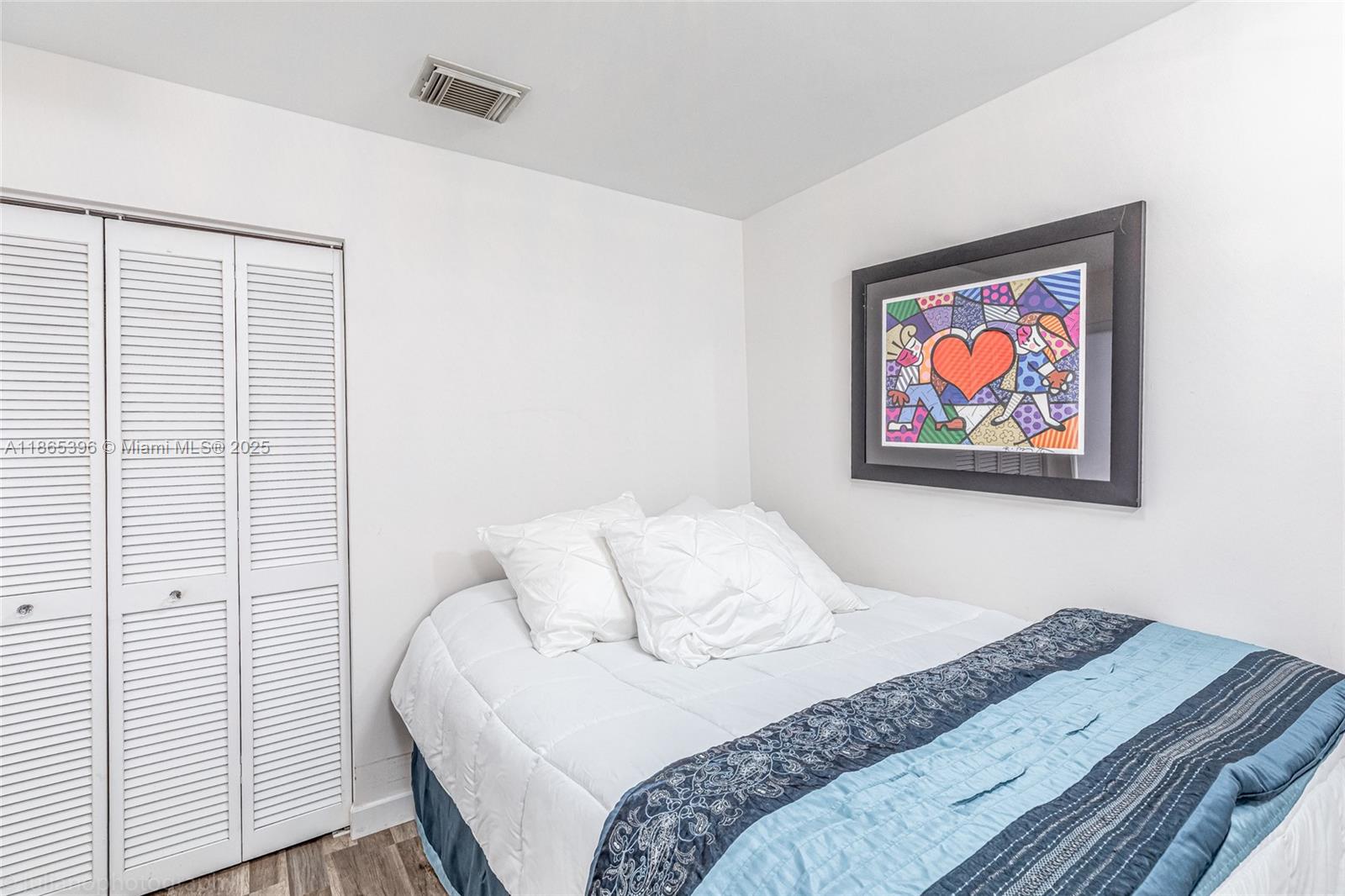 4913 Southwest 32nd Way Hollywood, FL 33312 - Photo 19 of 27 a bedroom with a bed and a wall painting