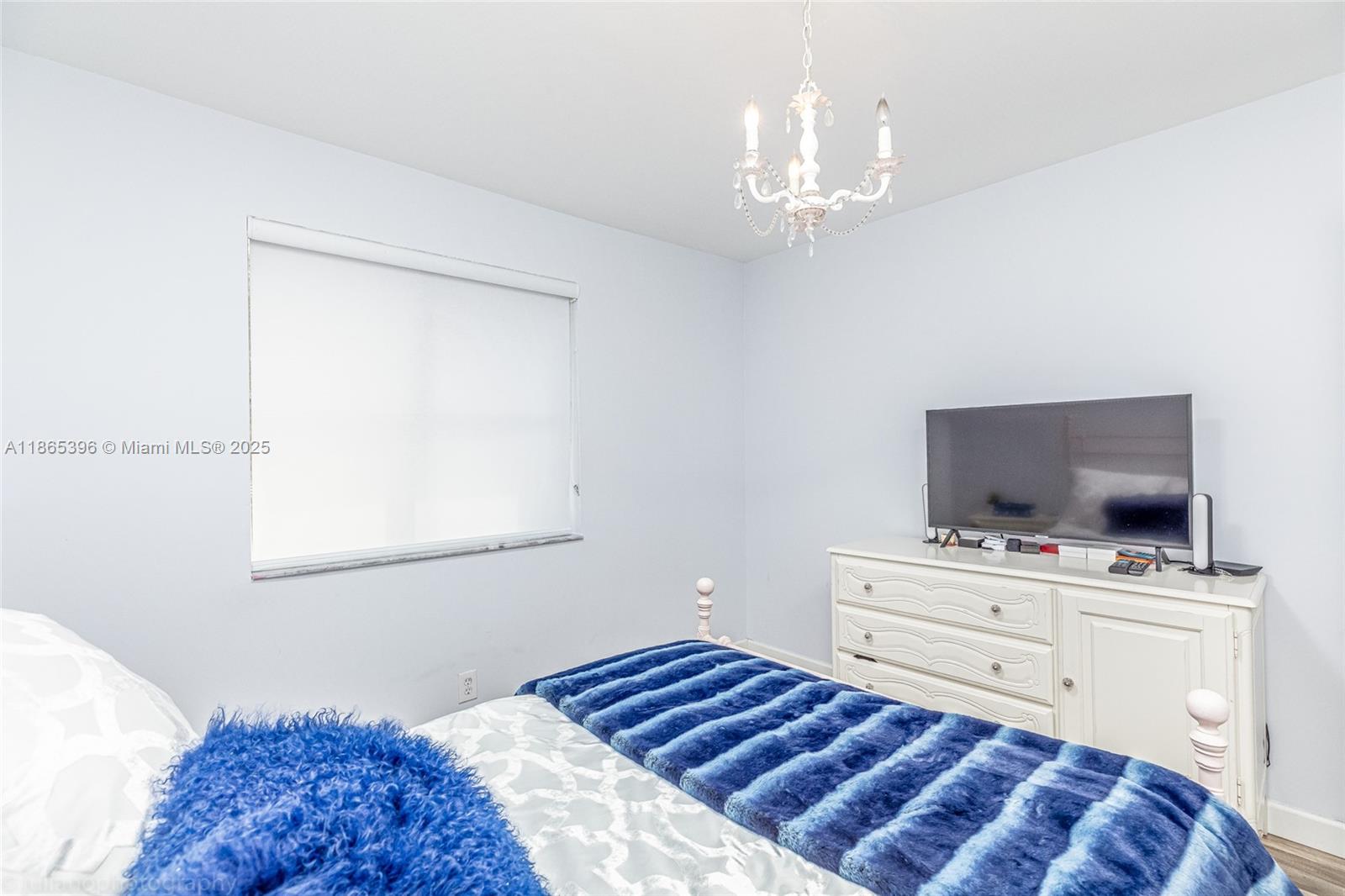 4913 Southwest 32nd Way Hollywood, FL 33312 - Photo 20 of 27 a bedroom with a bed and flat screen tv