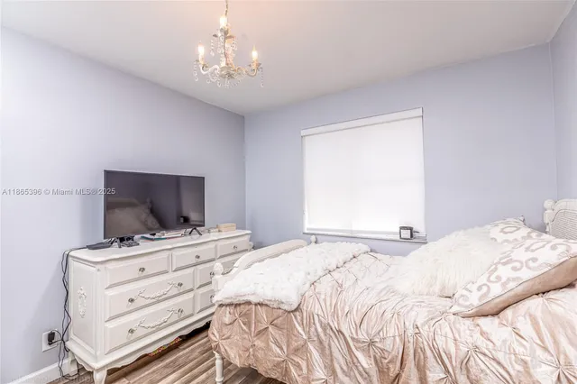 a bedroom with a bed and a tv