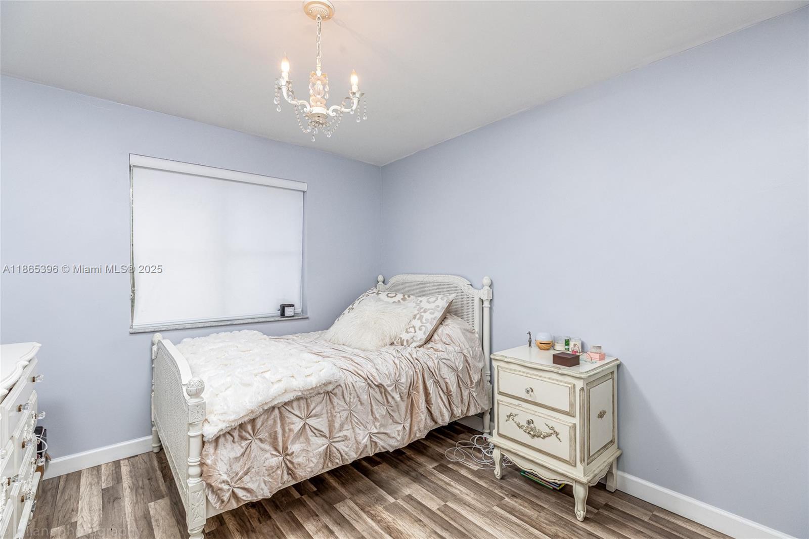 4913 Southwest 32nd Way Hollywood, FL 33312 - Photo 23 of 27 a bedroom with a bed and a table in it