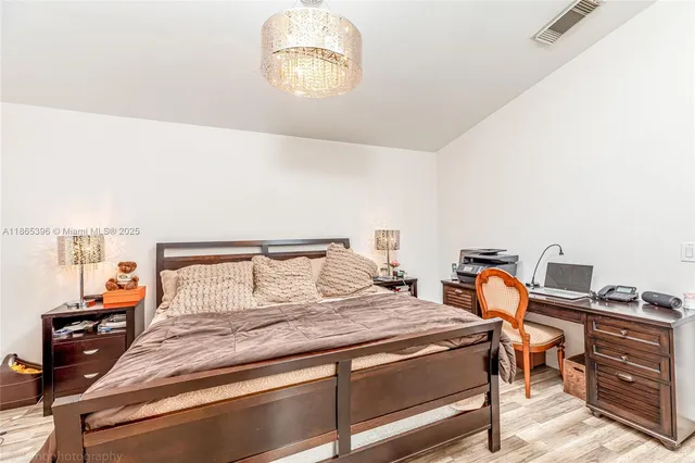 a bedroom with a bed and a desk