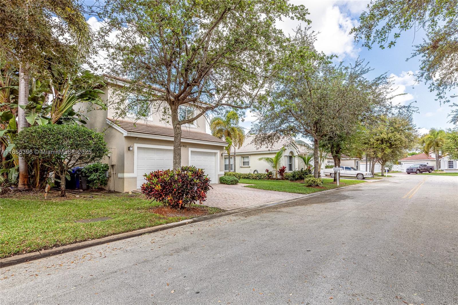 4913 Southwest 32nd Way Hollywood, FL 33312 - Photo 4 of 27 a front view of a house with a garden and trees
