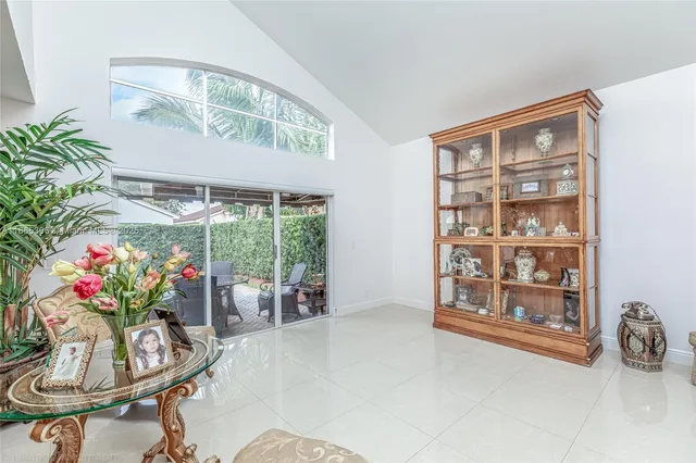 a dining room with furniture and a floor to ceiling window