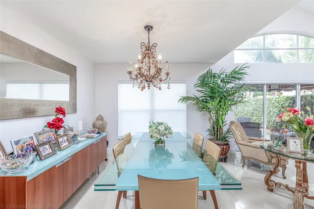 a view of a dining room with furniture and a chandelier