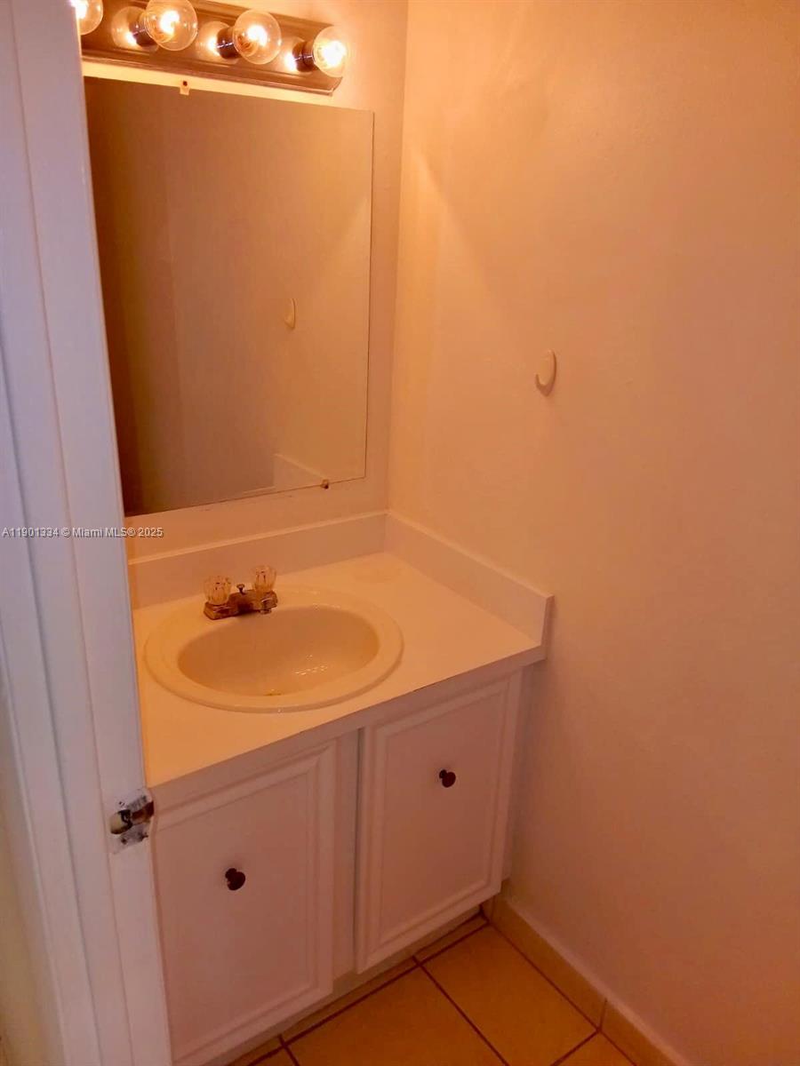 18051 Northwest 68th Avenue, Unit J102 Hialeah, FL 33015 - Photo 4 of 15 a bathroom with a sink and vanity