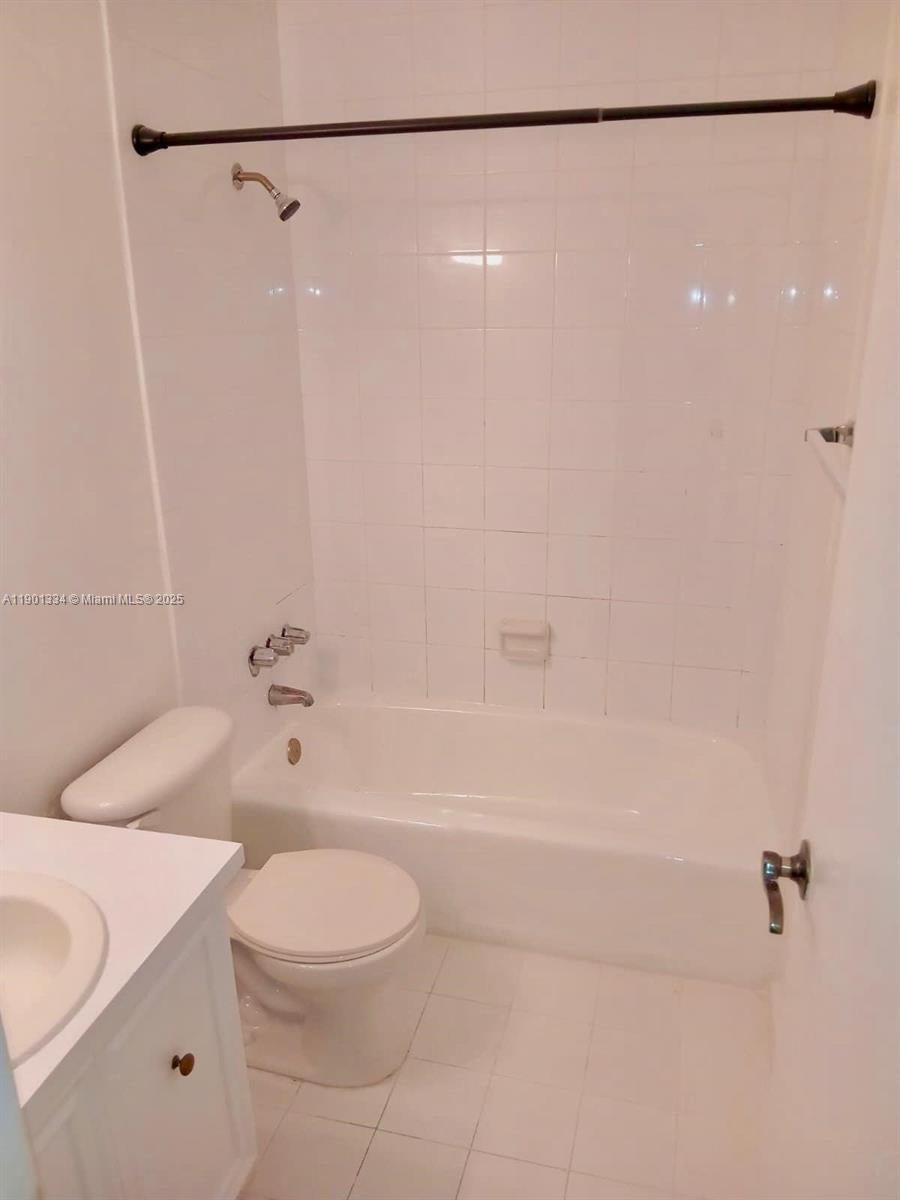 18051 Northwest 68th Avenue, Unit J102 Hialeah, FL 33015 - Photo 5 of 15 a bathroom with a toilet and a shower