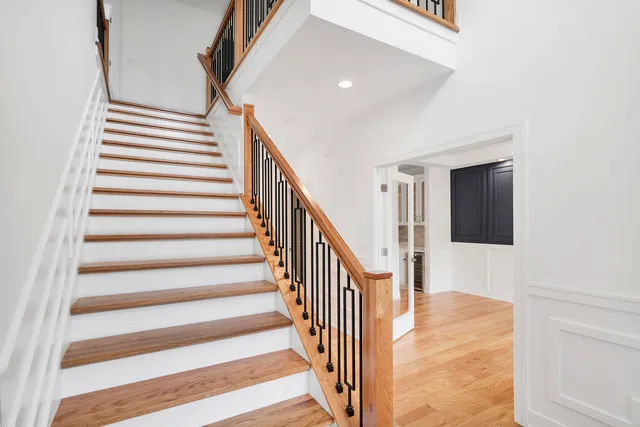 an empty room with a window and a ceiling fan