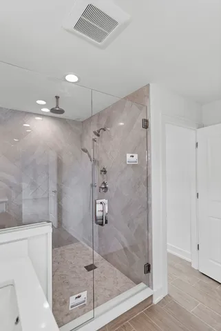 a large white kitchen with sink wooden floor and appliances
