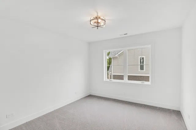 a bedroom with a bed and a potted plant