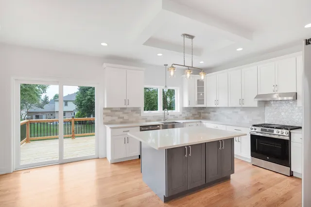 a kitchen with a refrigerator a sink and cabinets