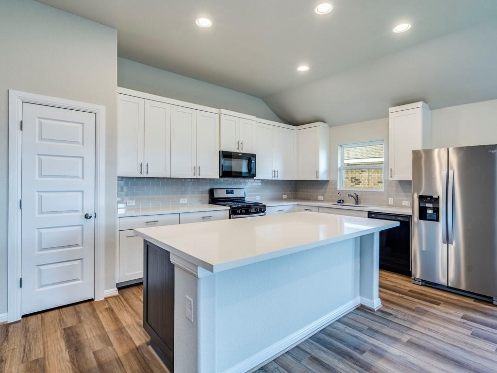 270 Rimrock Court Bastrop, TX 78602 - Photo 14 of 34 Inside, the open-concept kitchen is the heart of the home, featuring stainless steel appliances, a generous island, and plenty of space to gather, cook, and connect.