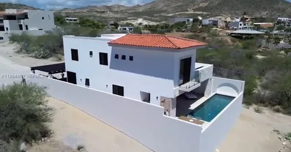 an aerial view of residential houses with outdoor space and river