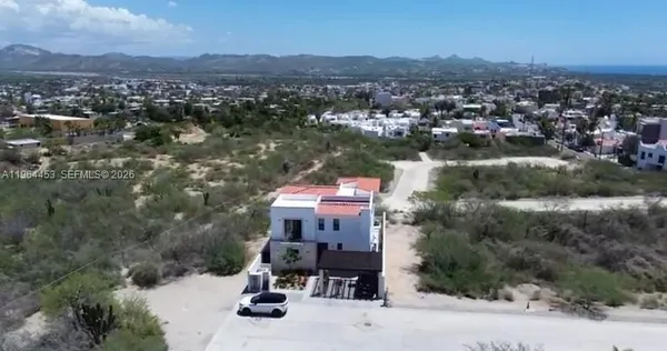 an aerial view of a house with a lake view