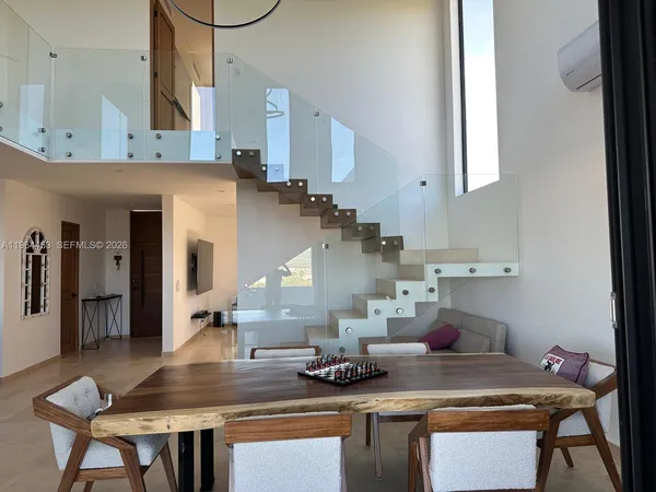 a kitchen with stainless steel appliances a table and chairs in it