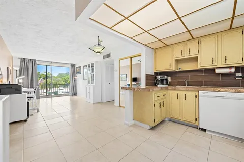 a room with furniture and a floor to ceiling window