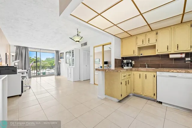 a spacious bedroom with a balcony a bed a table and chair