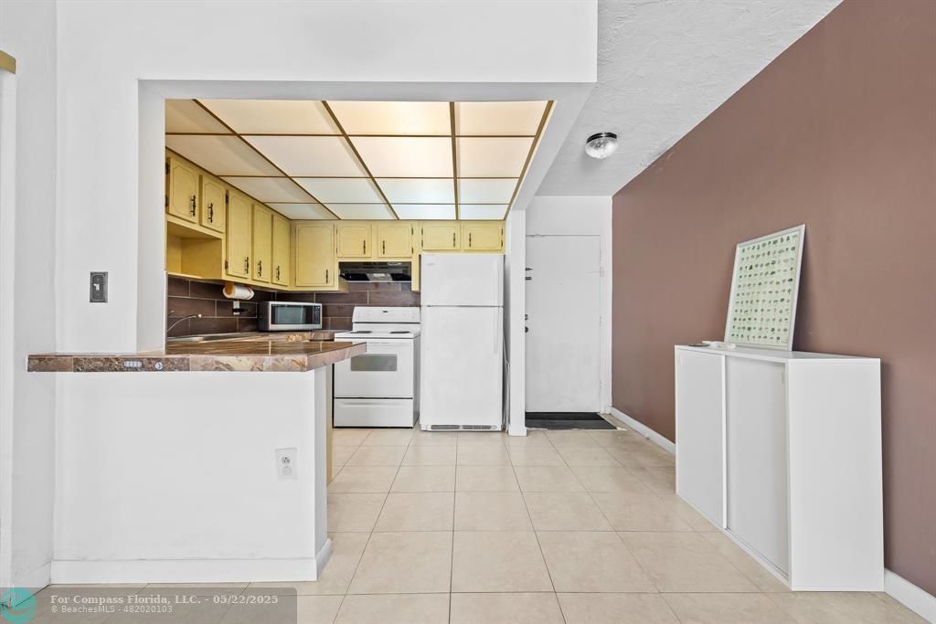 7100 Northwest 17th Street, Unit 218 Plantation, FL 33313 - Photo 5 of 13 a kitchen with a refrigerator a stove top oven and a dishwasher