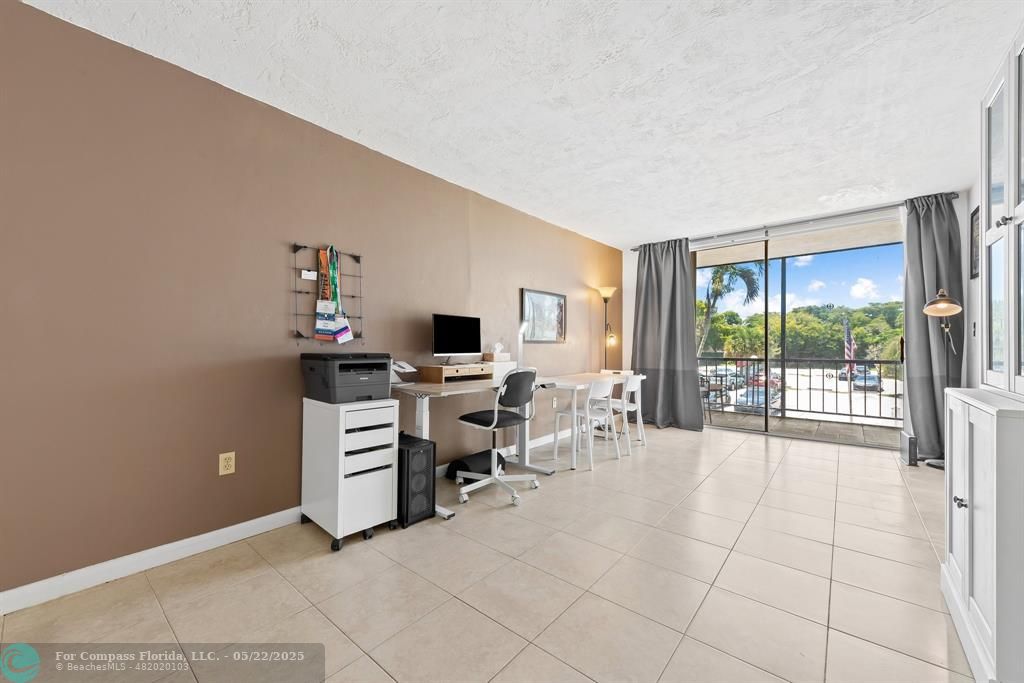 7100 Northwest 17th Street, Unit 218 Plantation, FL 33313 - Photo 6 of 13 a view of a livingroom with workspace and a window