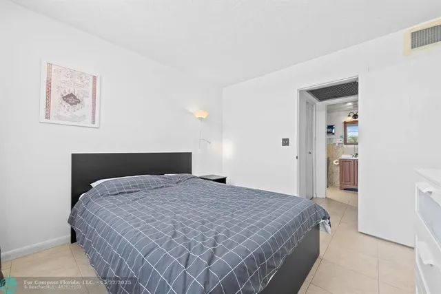 a bathroom with a granite countertop toilet a sink and a shower