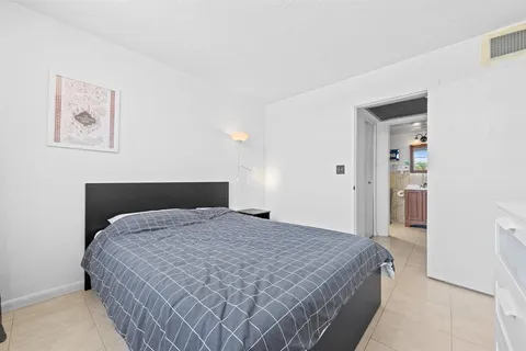 a bathroom with a granite countertop toilet sink and a shower