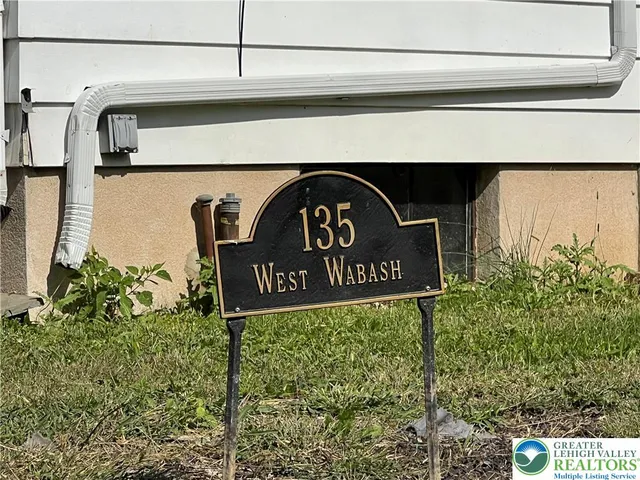 a kitchen with a sink a refrigerator and cabinets