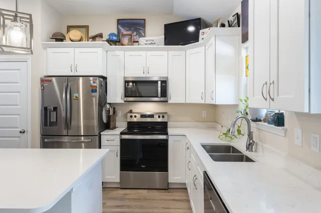 a kitchen with stainless steel appliances a stove microwave and a refrigerator