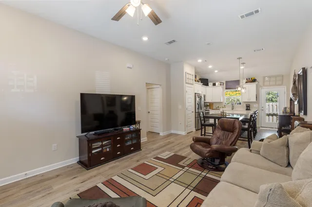 a living room with furniture and wooden floor