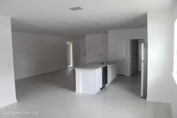 a view of a kitchen with white cabinets