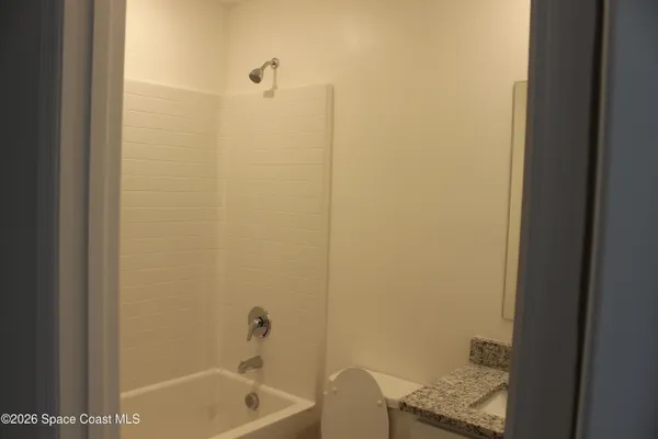 a bathroom with a tub and sink