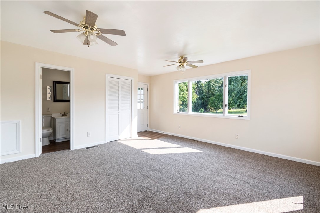 8131 Struthers Road Lowellville, OH 44436 - Photo 21 of 48 Unfurnished bedroom featuring carpet, ceiling fan, and ensuite bath