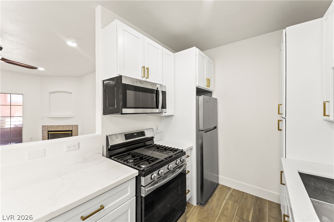4730 East Craig Road, Unit 1053 Las Vegas, NV 89115 - Photo 5 of 32 Modern kitchen with white shaker cabinets and sleek appliances, designed for culinary ease.