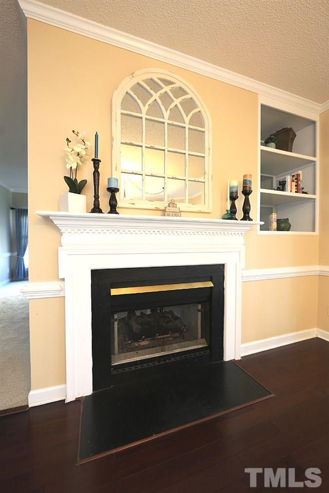 5628 Raddington Street Raleigh, NC 27613 - Photo 12 of 25 Two-sided fireplace in family room and kitchen