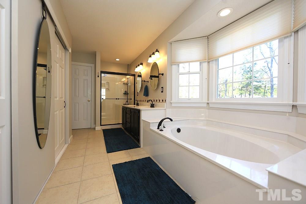 5628 Raddington Street Raleigh, NC 27613 - Photo 15 of 25 Updated master bath with soaking tub and separate shower.