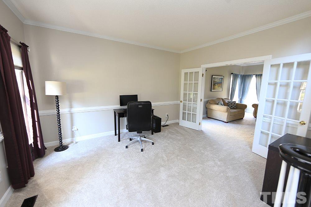 5628 Raddington Street Raleigh, NC 27613 - Photo 5 of 25 Living room opens to family room.