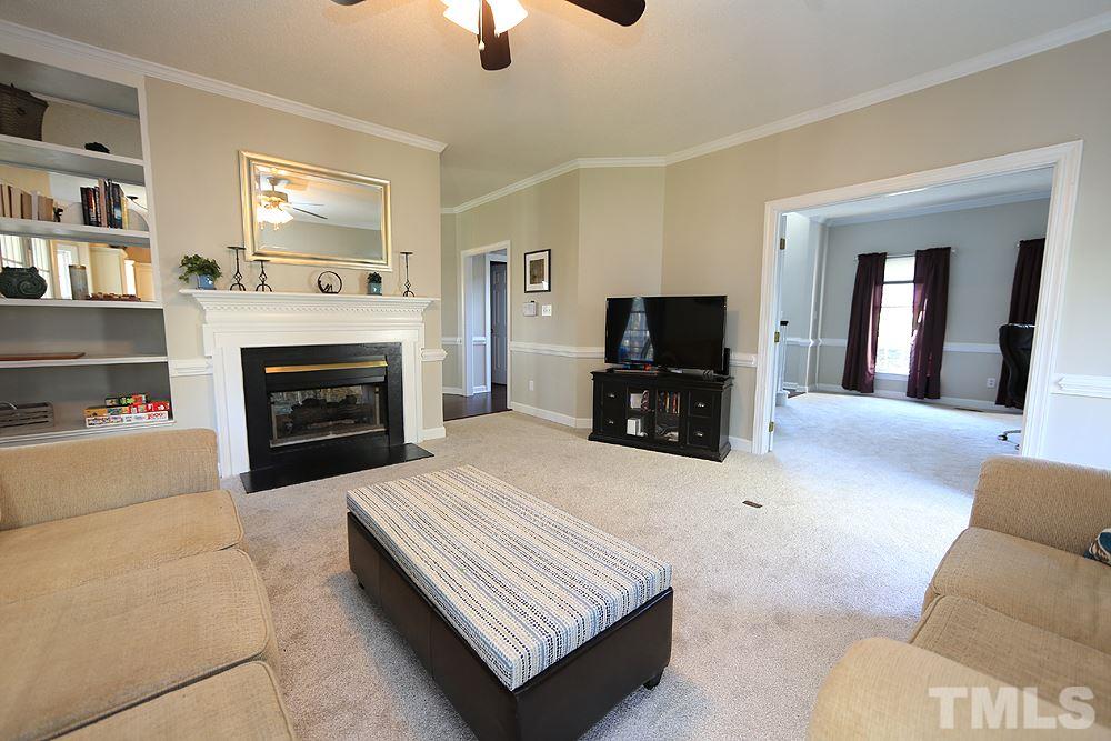 5628 Raddington Street Raleigh, NC 27613 - Photo 8 of 25 Fireplace and decorative bookshelf.