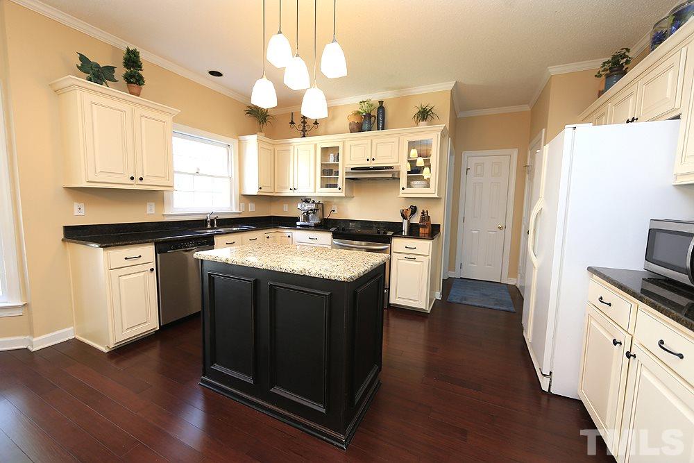 5628 Raddington Street Raleigh, NC 27613 - Photo 9 of 25 Beautifully updated kitchen with center island, granite counters, and hardwood floors.