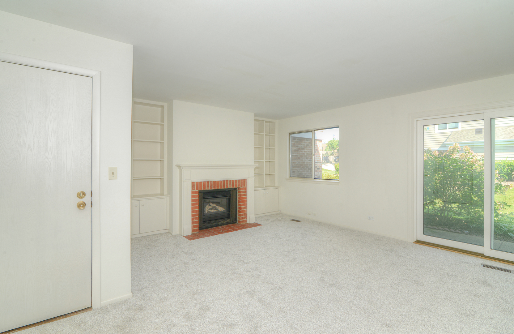 600 Eastview Court, Unit X1 Schaumburg, IL 60194 - Photo 15 of 35 a view of an empty room with a fireplace and a window