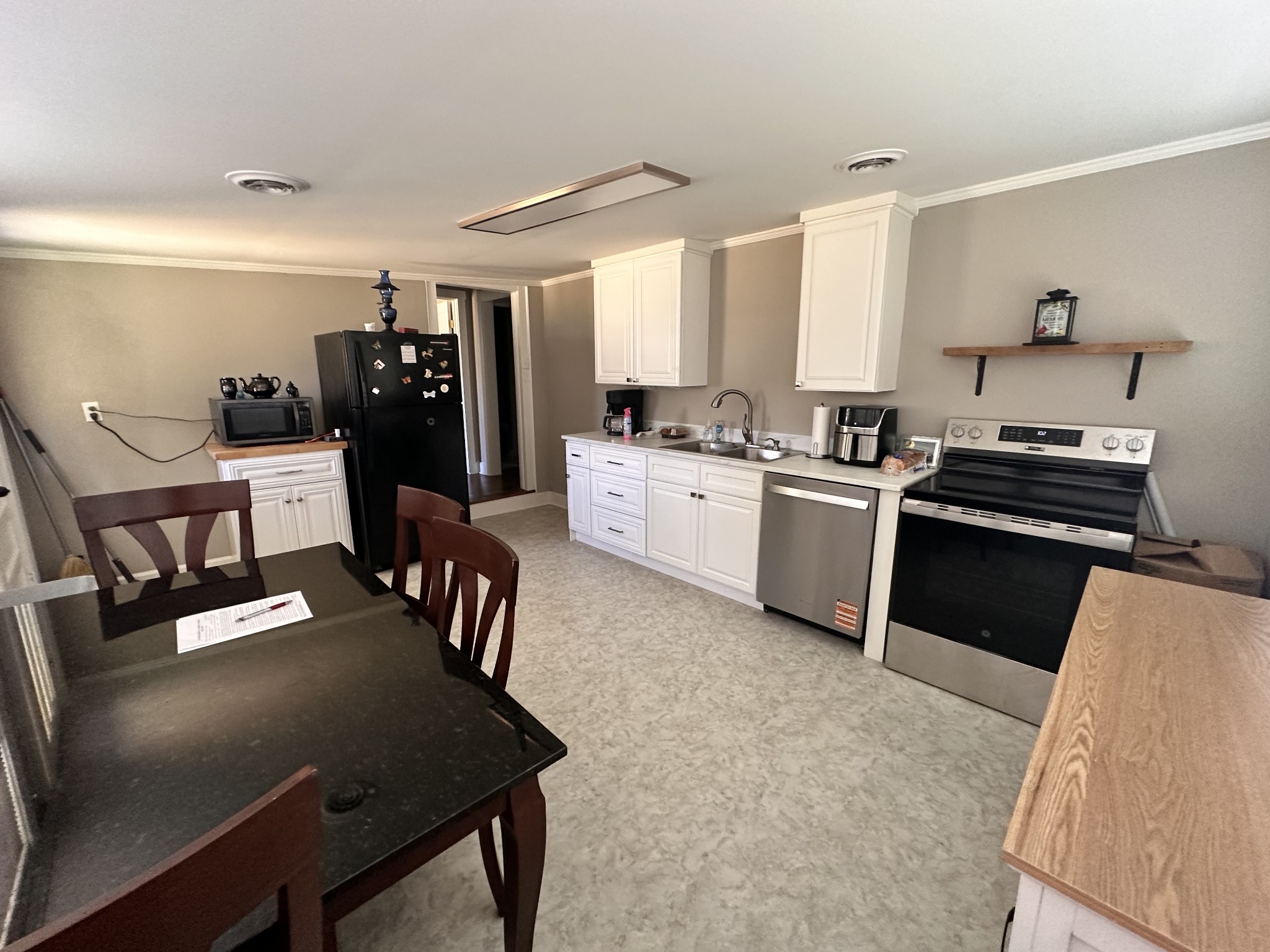 426 Frank Street Lawrenceburg, TN 38464 - Photo 13 of 17 a kitchen with a table chairs stove and refrigerator