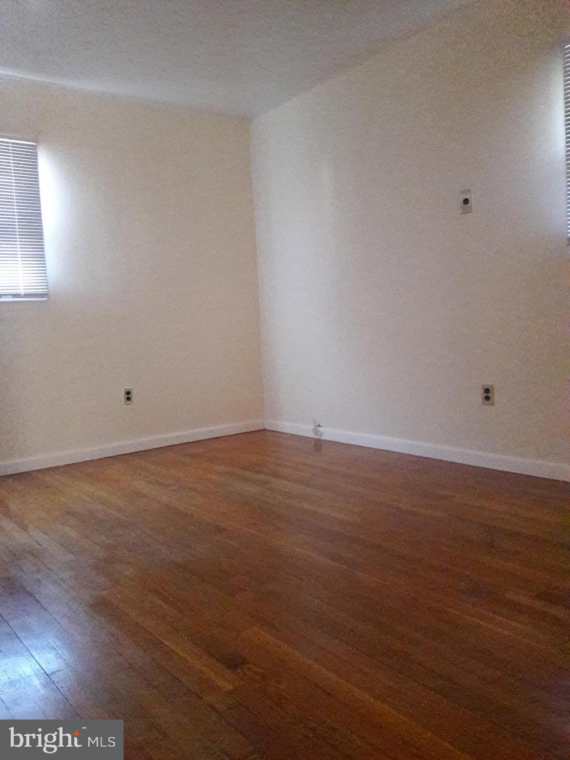 3113 Rheims Road Baltimore, MD 21244 - Photo 11 of 16 an empty room with wooden floor