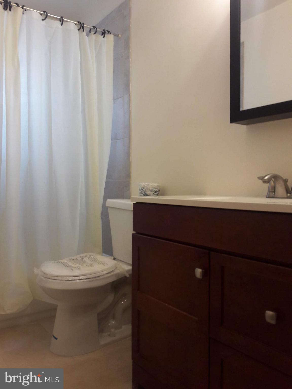 3113 Rheims Road Baltimore, MD 21244 - Photo 12 of 16 a bathroom with a sink toilet and shower