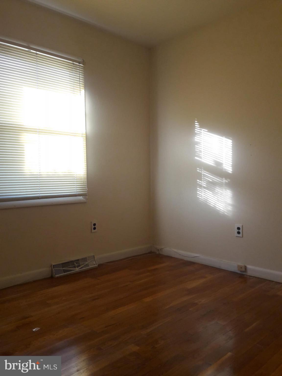 3113 Rheims Road Baltimore, MD 21244 - Photo 10 of 16 an empty room with wooden floor and windows