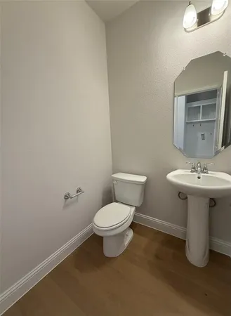 a bathroom with a sink toilet and a mirror