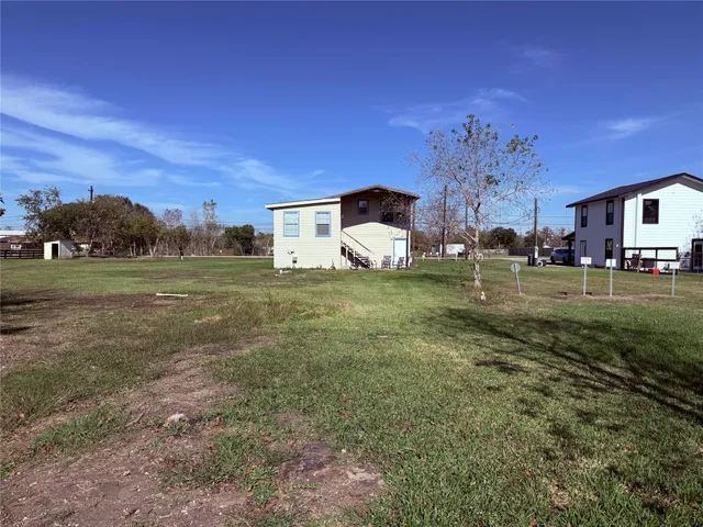 a view of a big room with a big yard and large tree