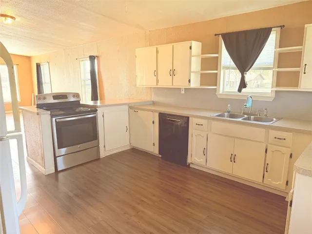 a kitchen with a stove a sink and a microwave