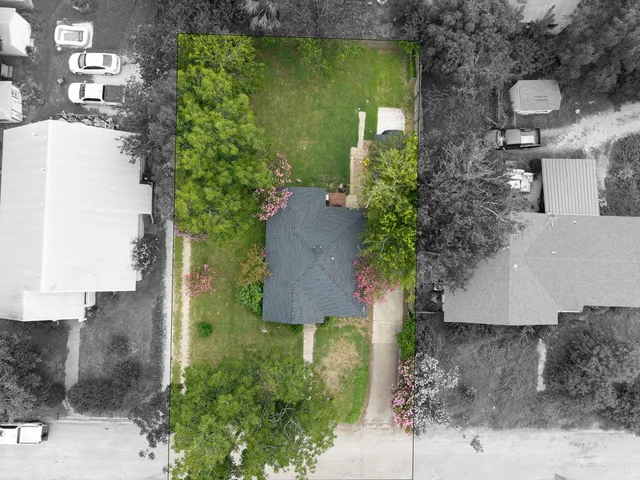 an aerial view of a house with a yard