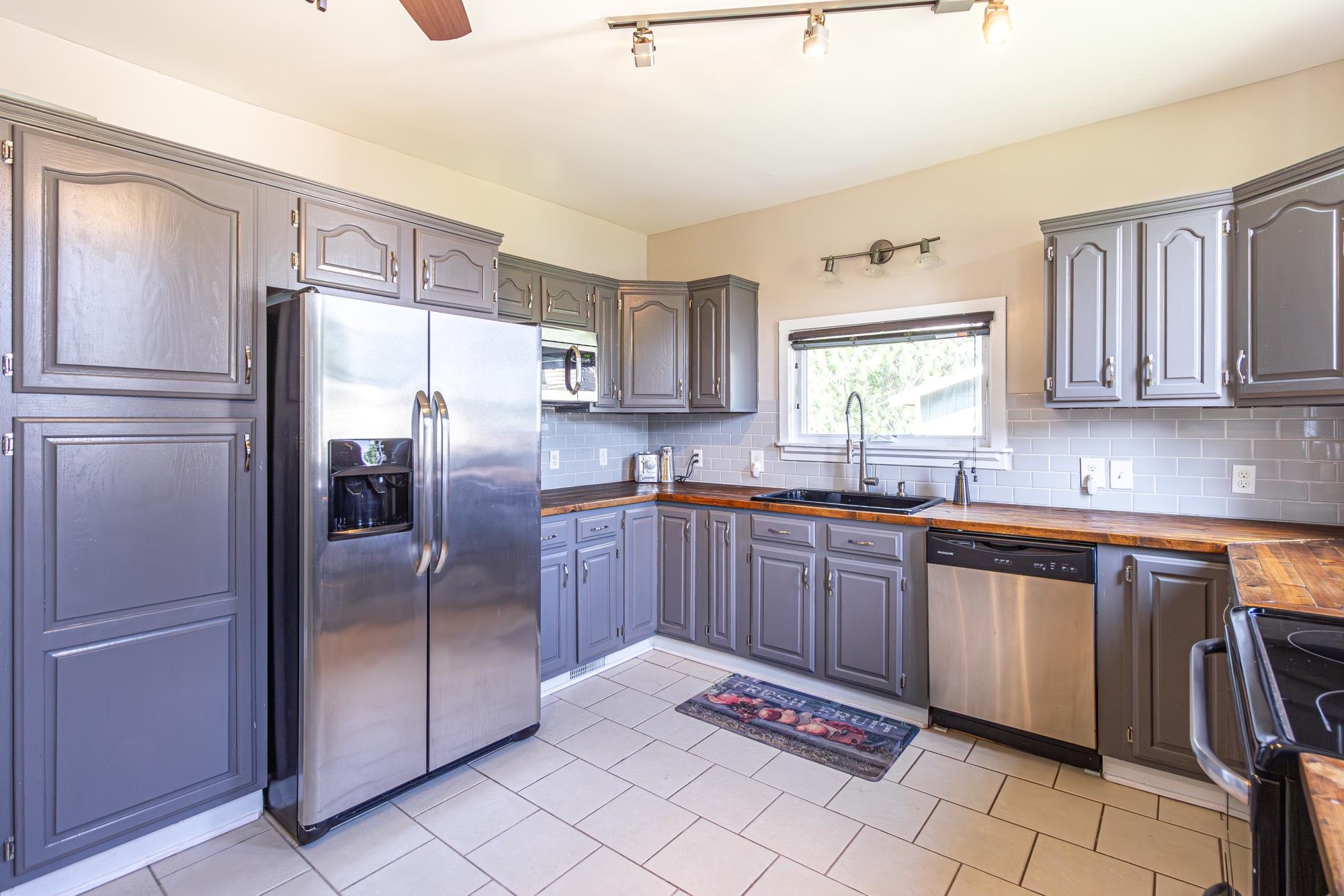 1151 East Camp Street Ely, MN 55731 - Photo 20 of 45 Kitchen with wood counters, tasteful backsplash, track lighting, and stainless steel appliances