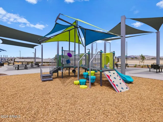 a sitting area with chairs and table in front of it