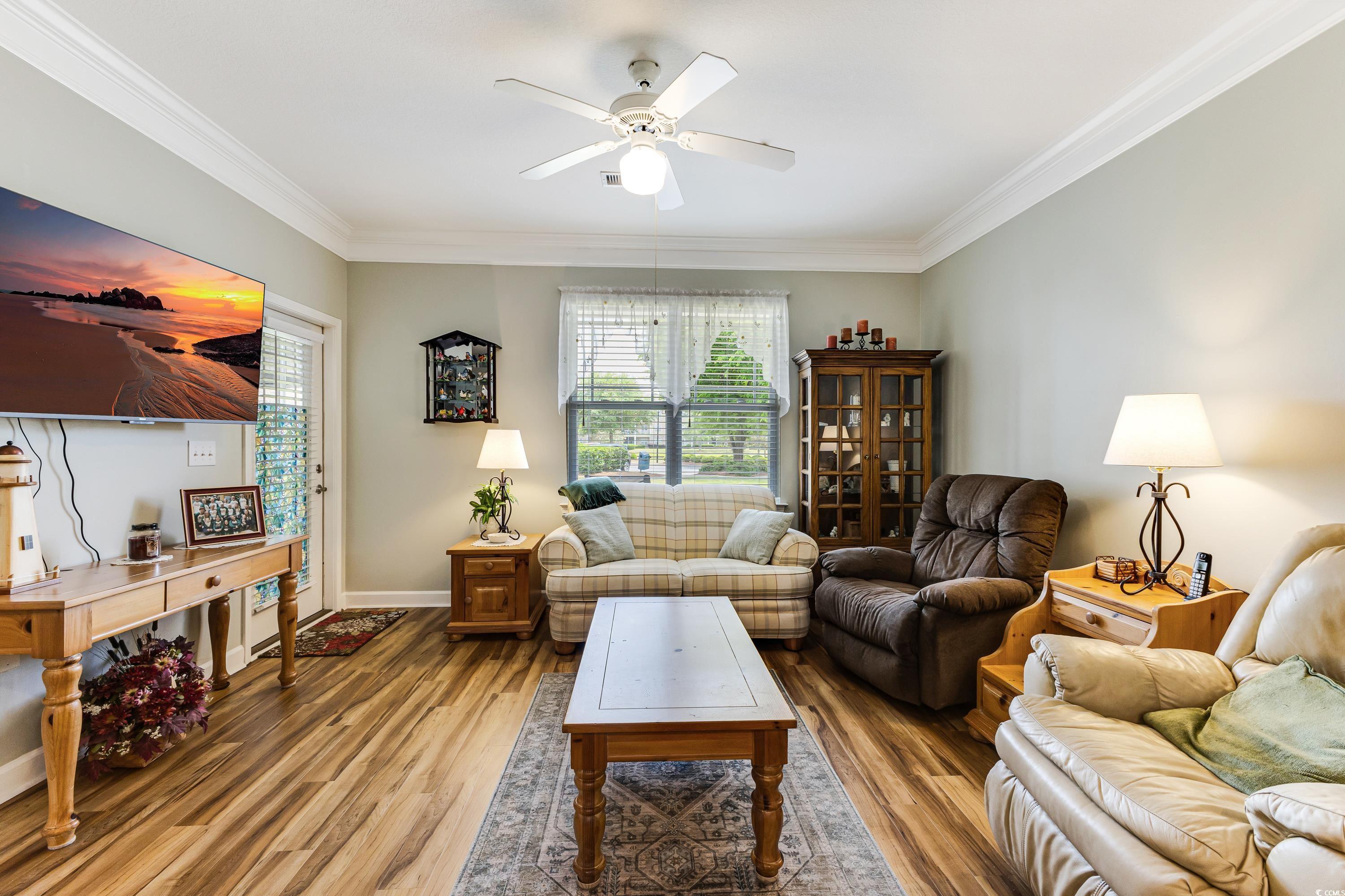 260 Woodlands Way, Unit 2 Calabash, NC 28467 - Photo 11 of 40 Living room with light wood-style flooring, ceiling fan, crown molding, and baseboards