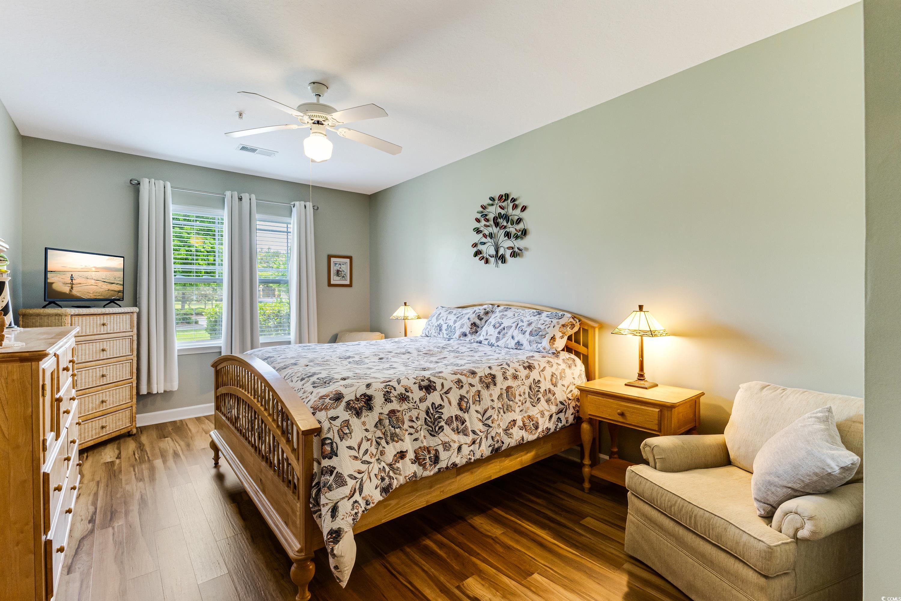 260 Woodlands Way, Unit 2 Calabash, NC 28467 - Photo 16 of 40 Bedroom with wood finished floors, ceiling fan, and baseboards